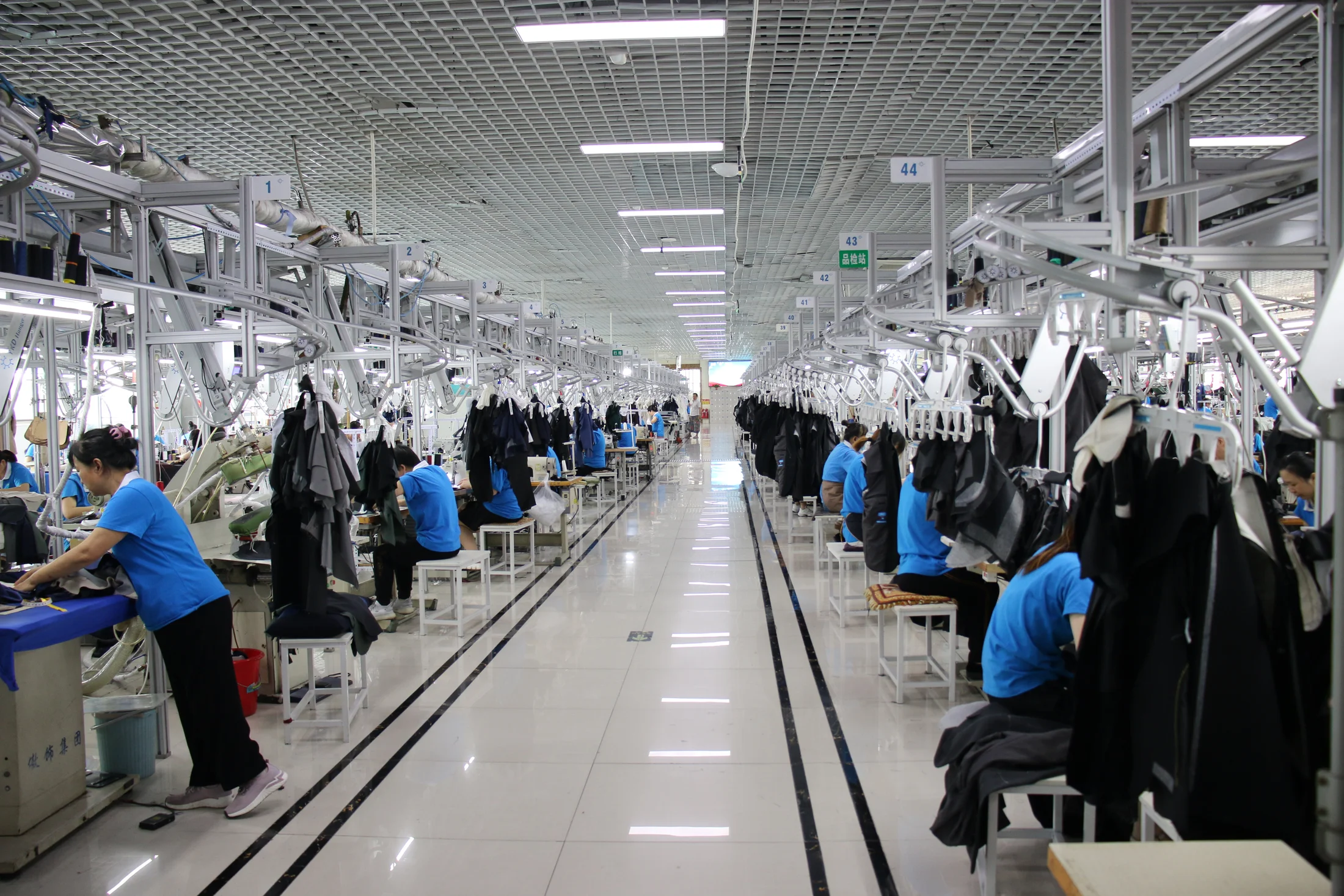 Aoshi garment makers at the suspended suit production line